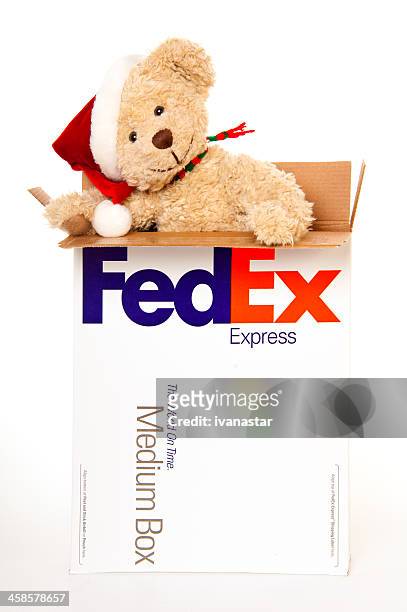 teddy bear ready to be shipped in fedex box - federal express stockfoto's en -beelden