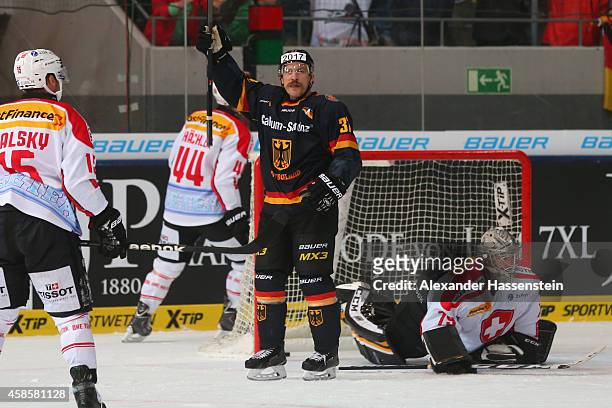 Patrick Reimer of Germany celebrates scoring the first goal against Daniel Manzato, goalie of Switzerland during match 2 of the Deutschland Cup 2014...