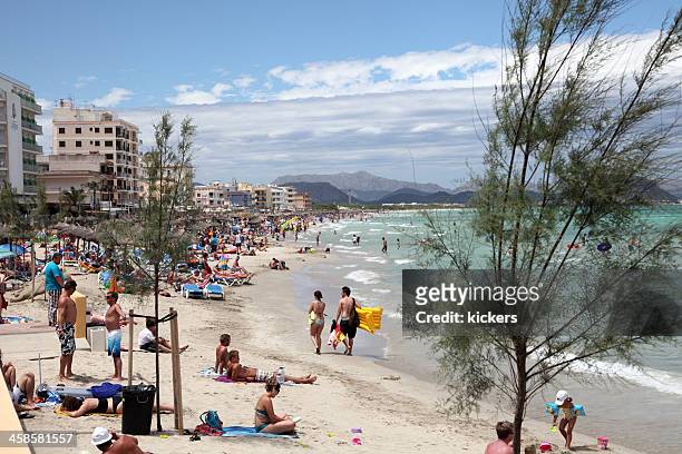 crowded beach on balearic islands - skimpy bathing suits stock pictures, royalty-free photos & images