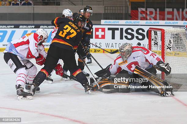 Patrick Reimer of Germany scores the second team goal against Daniel Manzato, goalie of Switzerland during match 2 of the Deutschland Cup 2014...