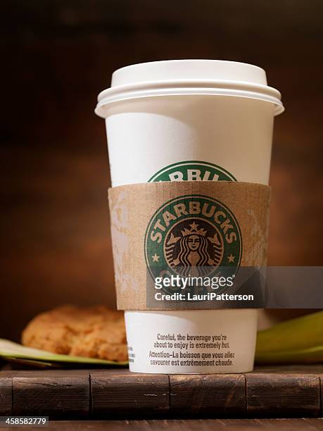 starbucks &quot;grande&quot; 16oz coffee with a peanut butter cookie - starbucks stock pictures, royalty-free photos & images