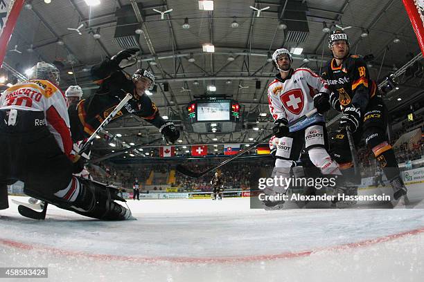 Patrick Reimer of Germany scores the second team goal against Daniel Manzato, goalie of Switzerland during match 2 of the Deutschland Cup 2014...