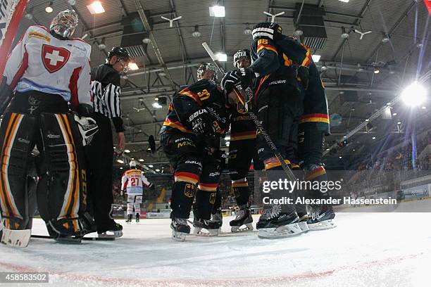 Patrick Reimer of Germany celebrates scoring the second team goal with his team mates against Daniel Manzato, goalie of Switzerland during match 2 of...