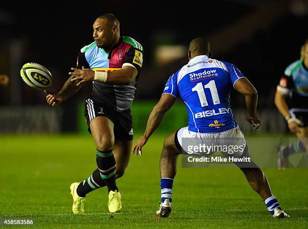 Jordan Turner-Hall of Harlequins passes as Aled Brew of Newport challenges during the LV= Cup match between Harlequins and Newport Gwent Dragons at...