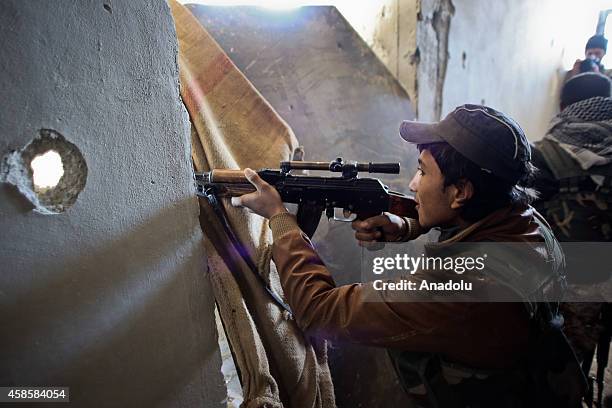 An armed Kurdish fighter boy is seen during the clashes with Islamic State of Iraq and Levant members in Kobani , Syria on November 7, 2014. ISIL...