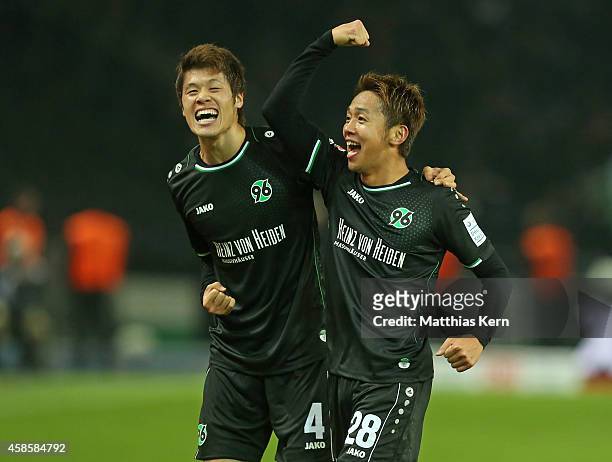 Hiroshi Kiyotake of Hannover jubilates with team mate Hiroki Sakai after scoring the second goal during the Bundesliga match between Hertha BSC and...