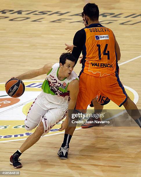 Thomas Heurtel, #22 of Laboral Kutxa Vitoria competes with Bojan Dubljevic, #14 of Valencia Basket in action during the 2014-2015 Turkish Airlines...