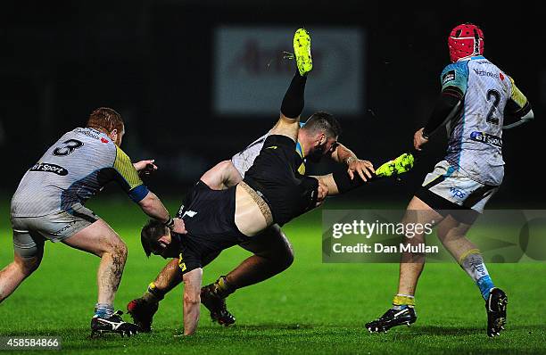 Matt Hankin of Saracens is upended by Gareth Thomas of Ospreys during the LV= Cup match between Ospreys and Saracens at The Gnoll on November 7, 2014...