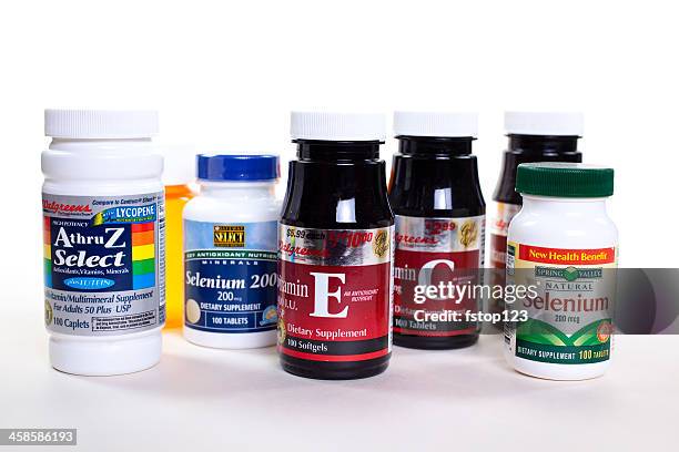 vitamin supplements in bottles on white background. - brand name stock pictures, royalty-free photos & images