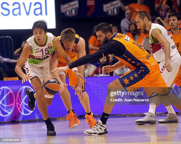 Bojan Dubljevic, #14 of Valencia Basket and Luke Harangody, #44 of Valencia Basket competes with Sasha Vujavic of Laboral Kutxa Vitoria in action...