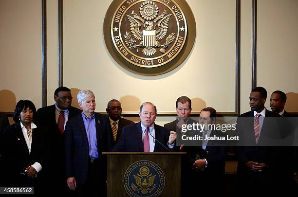 Detroit Mayor Mike Duggan , speaks as Michigan Governor Rick Snyder and Emergency Manager Kevyn Orr listen during a news conference November 7, 2014...