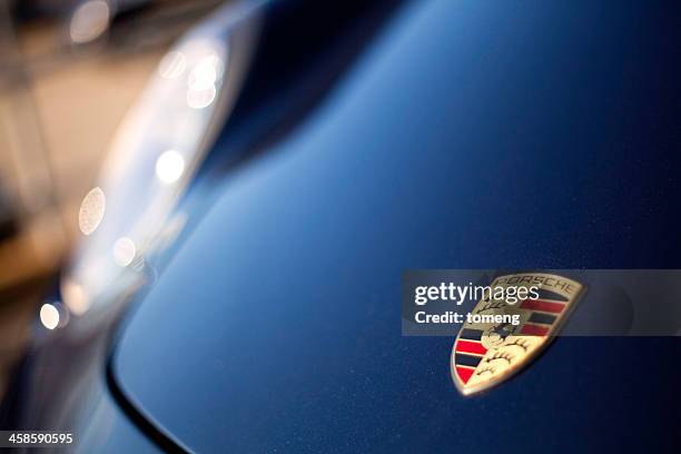 porsche logo on hood of cayman r - porsche cayman stock pictures, royalty-free photos & images