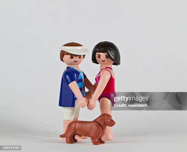 playmobil couple, man and women holding hands with dog - playmobil stock pictures, royalty-free photos & images