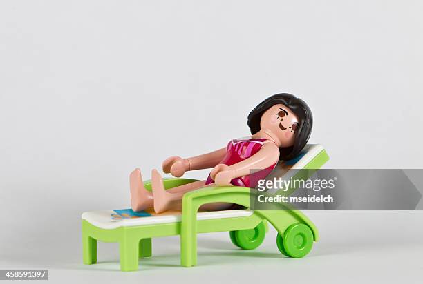 playmobil woman in bathing suit and lawn chair - playmobil stock pictures, royalty-free photos & images