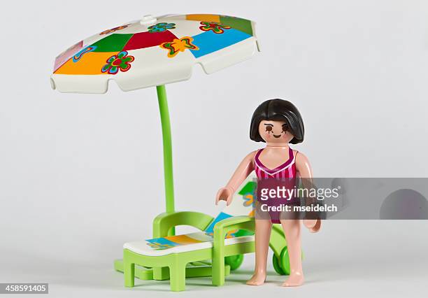playmobil woman in bathing suit, parasol and lawn chair - playmobil stock pictures, royalty-free photos & images