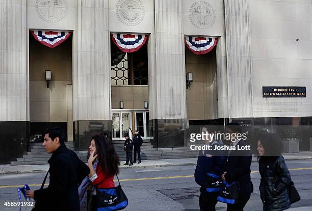 People walk past the Theodore Levin United States Courthouse November 7, 2014 in Detroit, Michigan. Today U.S. Bankruptcy Judge Steven Rhodes gave...