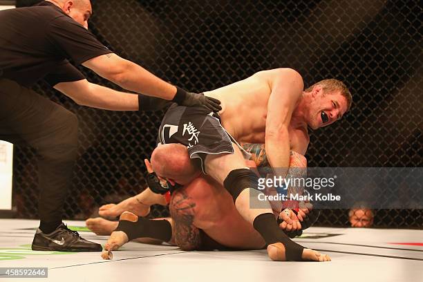 Daniel Kelly of Australia claims victory with an arm bar over Zachrich in their middleweight fight during the UFC Fight Night 55 event at Allphones...