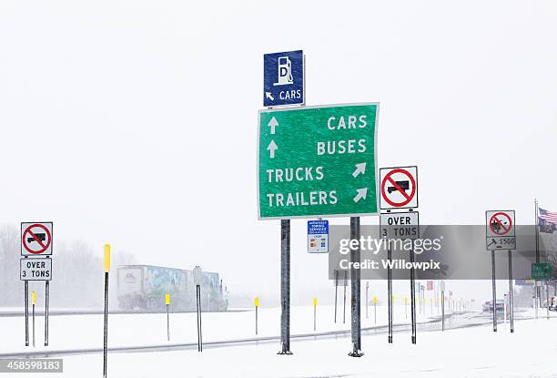 multiple signs at thruway rest stop in winter blizzard - rest area sign stock pictures, royalty-free photos & images
