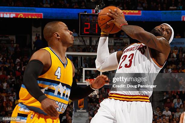 LeBron James of the Cleveland Cavaliers is fouled by Randy Foye of the Denver Nuggets at Pepsi Center on November 7, 2014 in Denver, Colorado. NOTE...