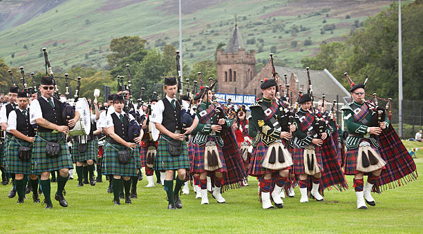 massed pipe bands at brodick highland games, arran. - highland games stock pictures, royalty-free photos & images