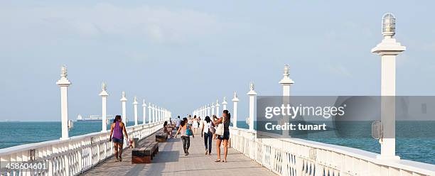 people walking on the wooden english bridge in fortaleza, brazil - fortaleza stock pictures, royalty-free photos & images