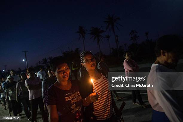 Residents of San Joaquin walk through the towns streets during a dawn candle light procession on November 8, 2014 in Tacloban, Leyte, Philippines....