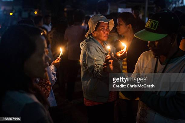 Residents of San Joaquin prepare to take part in a dawn candle light procession on November 8, 2014 in Tacloban, Leyte, Philippines. Residents and...