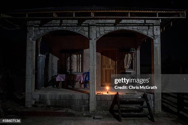 Single candle is seen lit at a house in San Joaquin on November 8, 2014 in San Joaquin, Leyte, Philippines. Residents and typhoon survivors from...