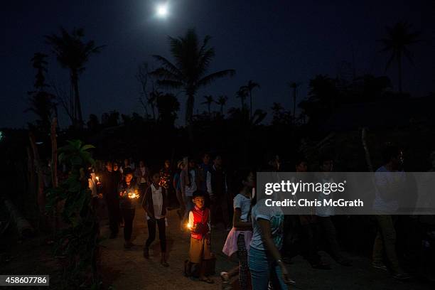 Residents of San Joaquin walk through the towns streets during a dawn candle light procession on November 8, 2014 in Tacloban, Leyte, Philippines....