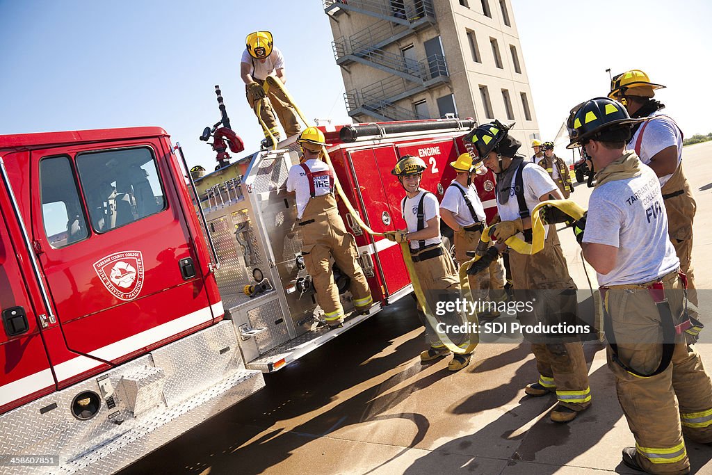 Firefighters Loading Up Fire Hose After Training Exercise