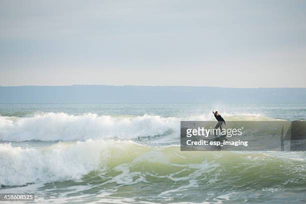 man surfing in croyde bay devon - croyde stock pictures, royalty-free photos & images