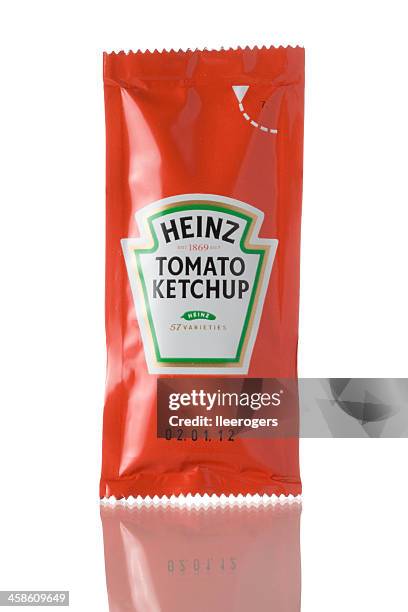 sachet of heinz tomato ketchup on a white background - schets stock pictures, royalty-free photos & images