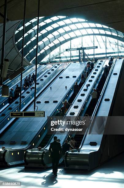 canary wharf tube station escalators, london - canary wharf railway station stock pictures, royalty-free photos & images