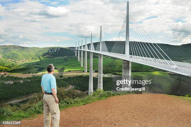 man looking at millau viaduct, france - millau viaduct stock pictures, royalty-free photos & images