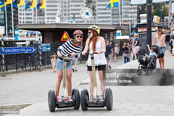 tourists on skeppsbron stockholm in the summer trying out segways. - segway 個照片及圖片檔