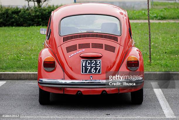 old red volkswagen beetle in the street - beetle car stock pictures, royalty-free photos & images