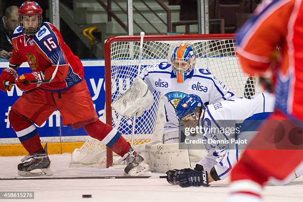 Georgi Ivanov of Russia battles against Kimmo Rautiainen of Finland during semifinals at the World Under-17 Hockey Challenge on November 7, 2014 at...