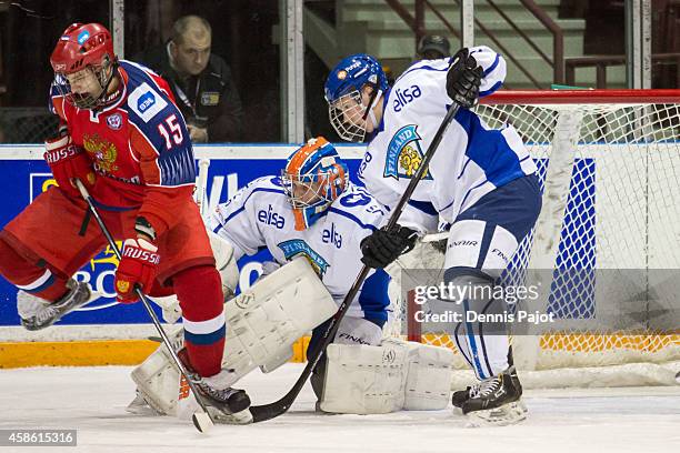 Georgi Ivanov of Russia tips the puck against Kimmo Rautiainen of Finland during semifinals at the World Under-17 Hockey Challenge on November 7,...