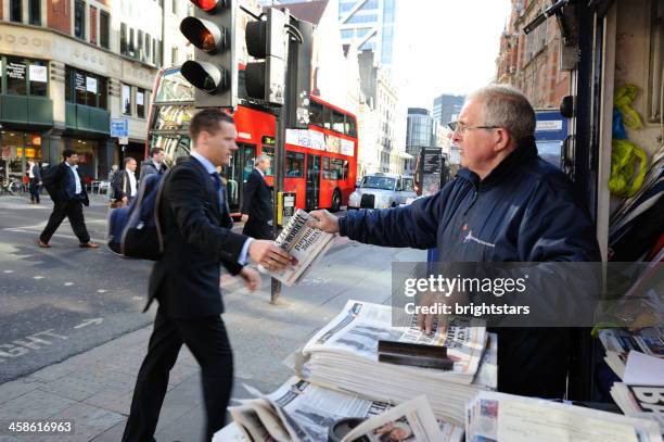 businessman gets a free newspaper in london - tidningsstånd bildbanksfoton och bilder