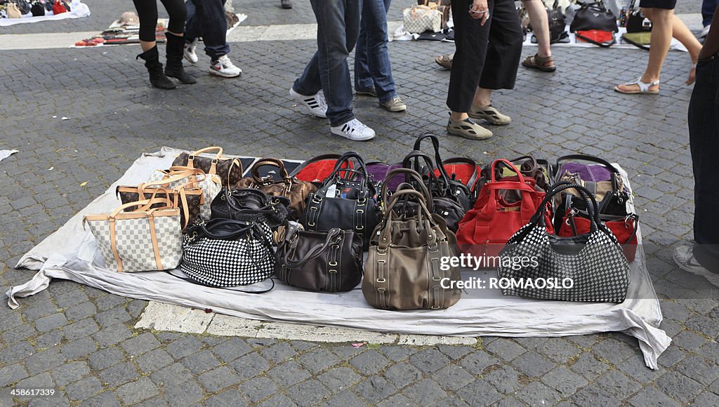 Selling fake designer bags on the street in Rome, Italy