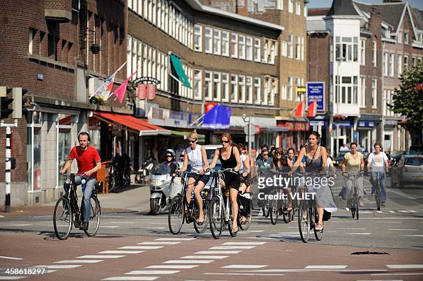 cyclists crossing an intersection in utrecht the netherlands - utrecht stockfoto's en -beelden