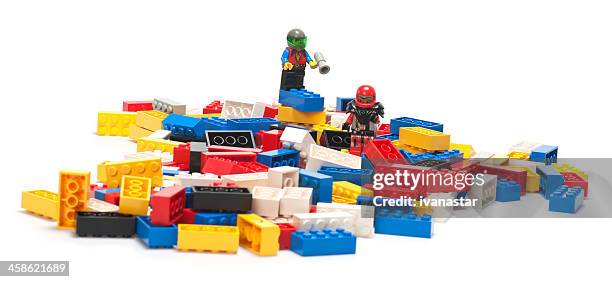 pile of lego blocks with astronaut figurines on top - plastic block stock pictures, royalty-free photos & images