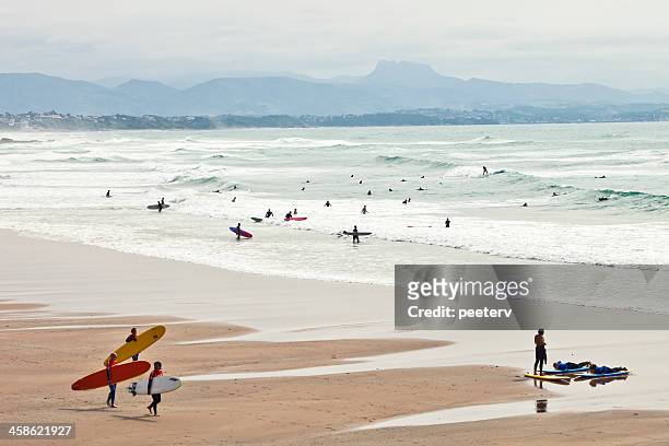 surfers at the beach - biarritz stockfoto's en -beelden