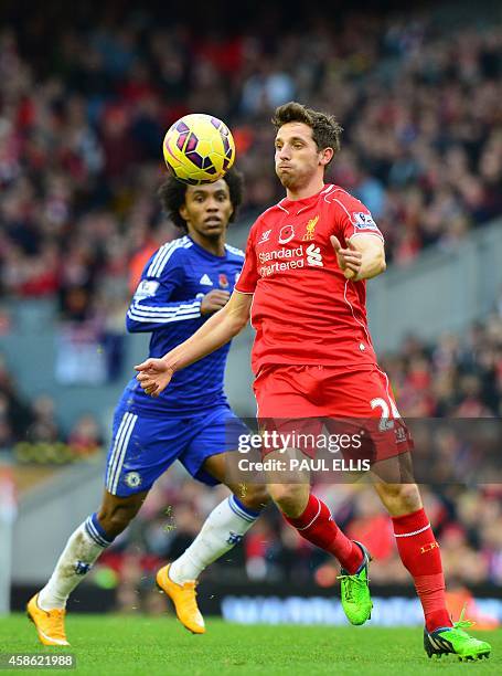 Liverpool's Welsh midfielder Joe Allen controls the ball under pressure from Chelsea's Brazilian midfielder Willian during the English Premier League...