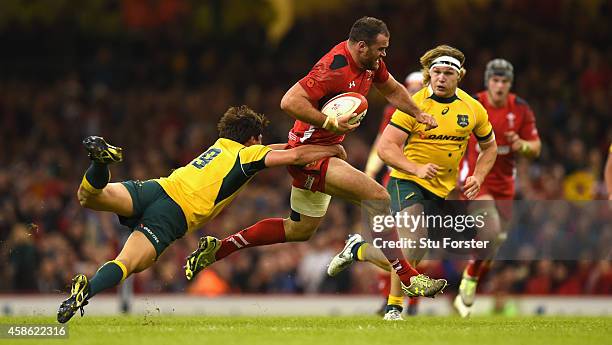 Wales player Jamie Roberts is tackled by Wallabies player Nick Phipps during the Autumn international match between Wales and Australia at Millennium...