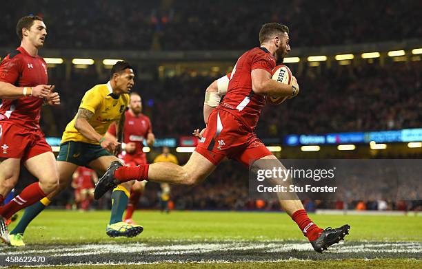 Wales wing Alex Cuthbert crosses to score the second try during the Autumn international match between Wales and Australia at Millennium Stadium on...