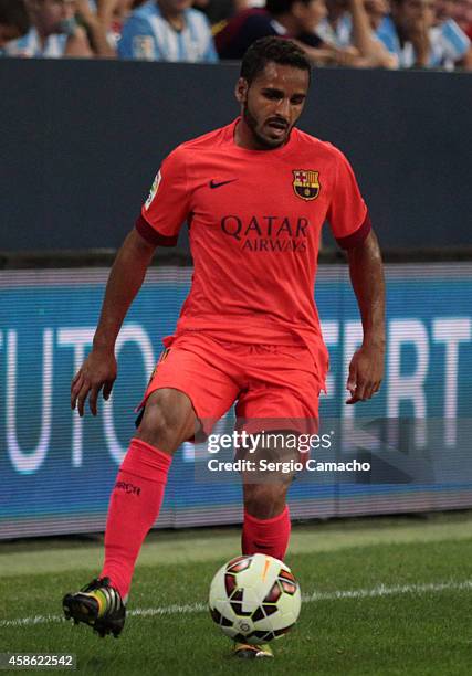 Douglas of Barcelona in action during the La Liga match between Malaga CF and FC Barcelona at La Rosaleda studium on September 24, 2014 in Malaga,...