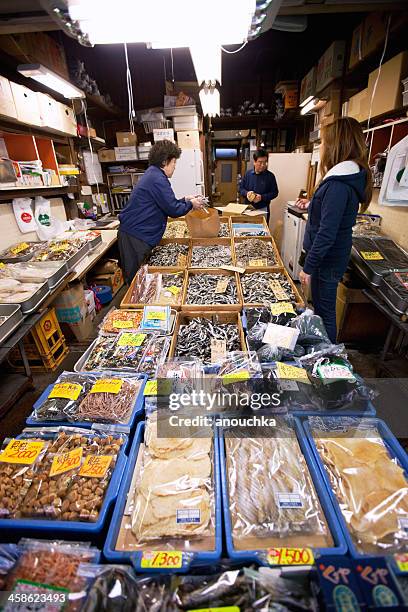 vendors serving customers, tsukiji fish market, tokyo - tsukiji fish market stock pictures, royalty-free photos & images