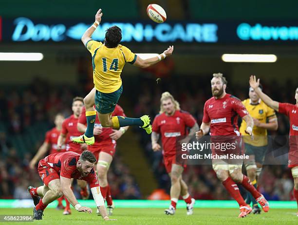 Adam Ashley-Cooper of Australia is airborne after a challenge from Alex Cuthbert of Wales during the International match between Wales and Australia...