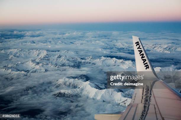 ryanair flight on swiss italian alps, aerial view - ryanair stock pictures, royalty-free photos & images